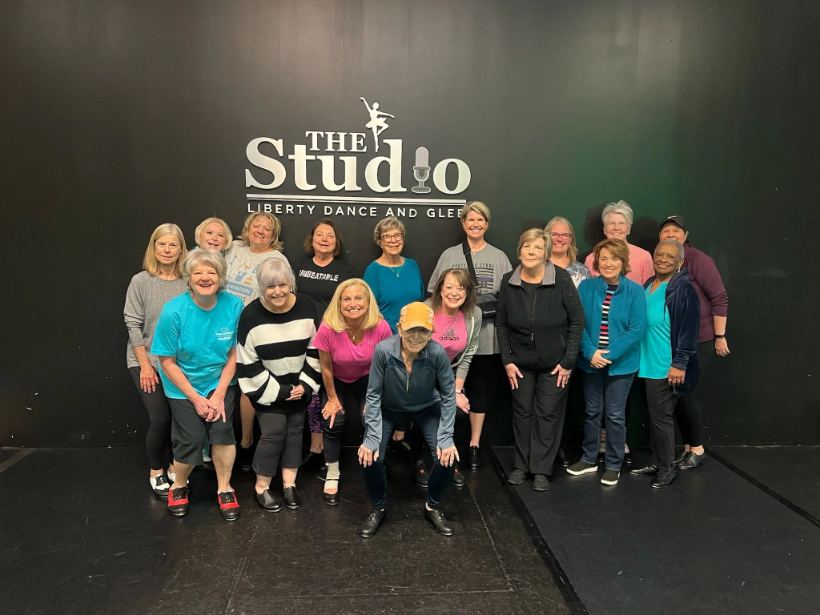 Adult dancers in the daytime tap class, mid step