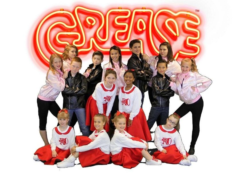 A Glee class singing and dancing together