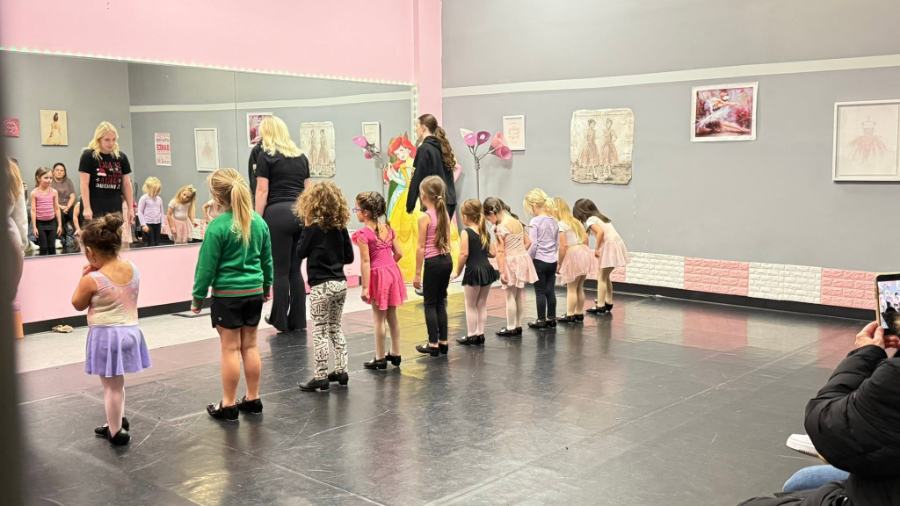 A line of the youngest tap dancers in the pink room, working with two teachers