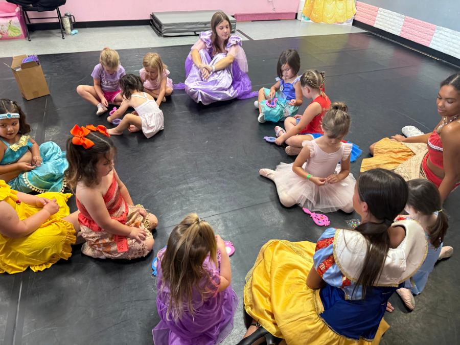 A birthday party circle, little ones in princess costumes with their party hosts
